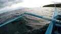 Boat outriggers moving through ocean waves